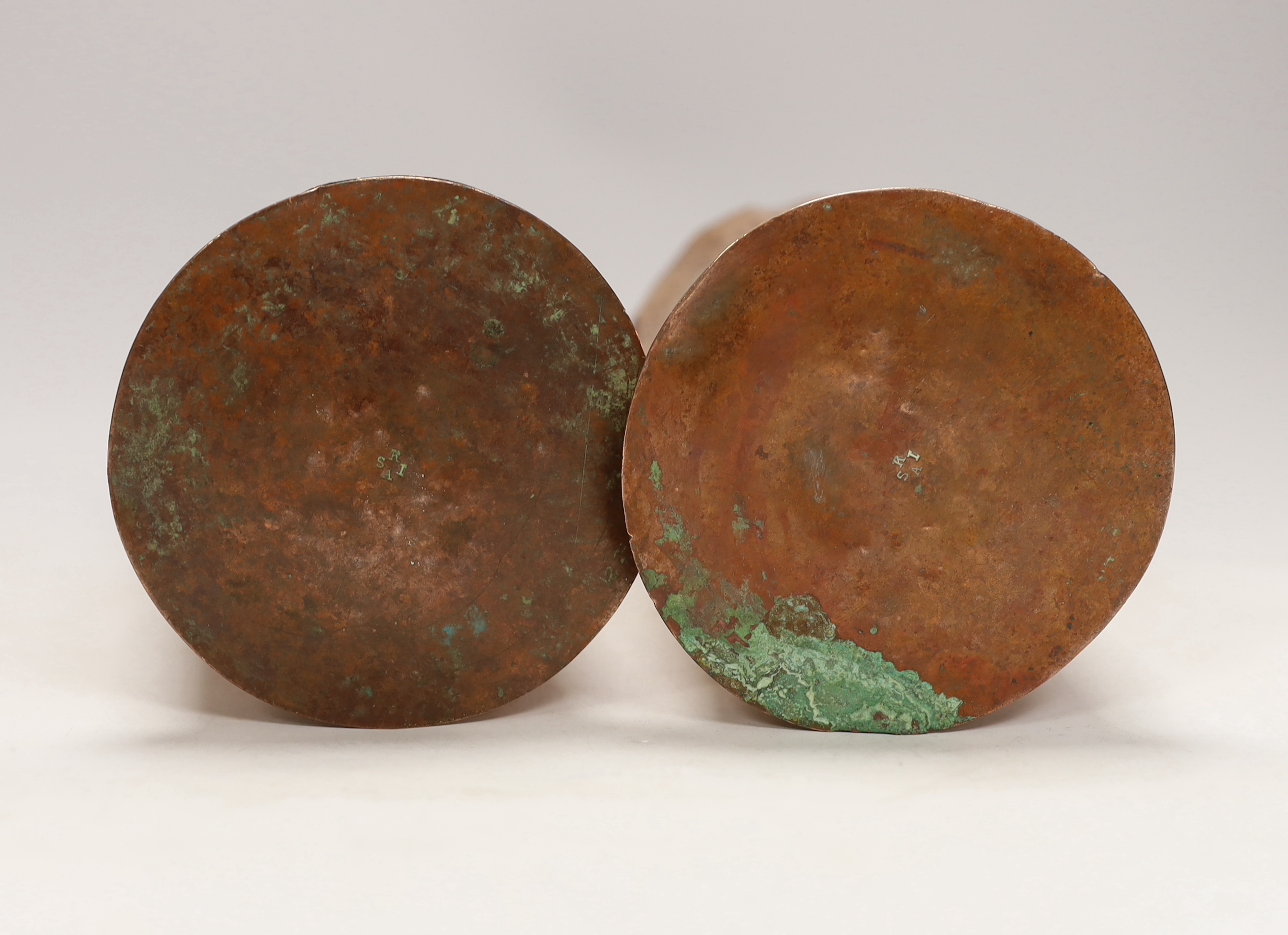 A pair of Keswick School of industrial art embossed copper cylinder vases, stamped KSIA to the bases, 20cm high